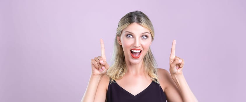 Alluring portrait of beautiful woman with perfect makeup clean skin pointing finger up in pink copyspace isolated background. Promotion indicated by hand gesture concept for skincare advertisement.