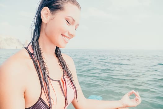 Woman sup yoga. Happy young sporty woman practising yoga pilates on paddle sup surfboard. Female stretching doing workout on sea water. Modern individual female outdoor summer sport activity