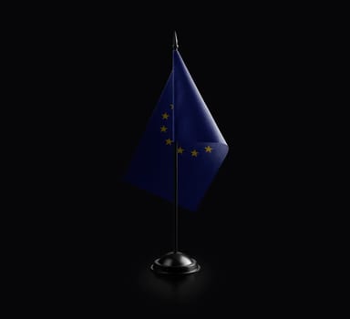 Small national flag of the European Union on a black background.