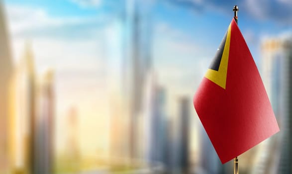 Small flags of the East Timor on an abstract blurry background.