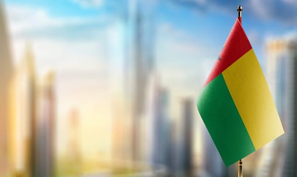 Small flags of the Guinea Bissau on an abstract blurry background.
