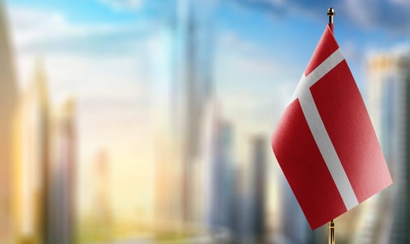 Small flags of the Denmark on an abstract blurry background.