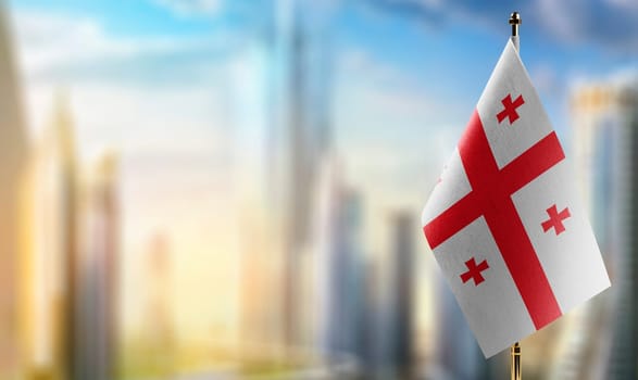 Small flags of the Georgia on an abstract blurry background.