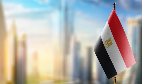 Small flags of the Egypt on an abstract blurry background.