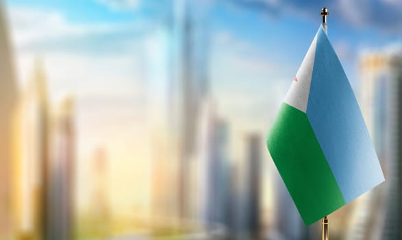 Small flags of the Djibouti on an abstract blurry background.