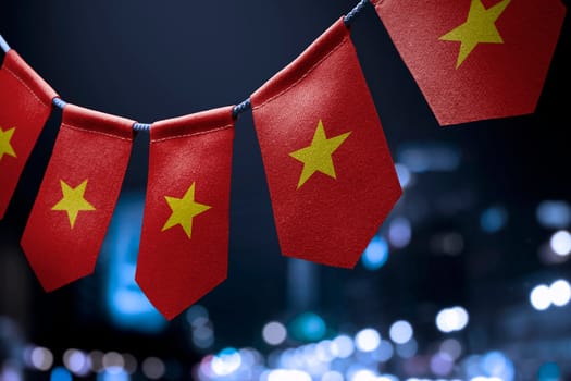 A garland of Vietnam national flags on an abstract blurred background.