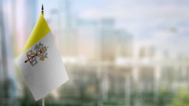 Small flags of the Vatican on an abstract blurry background.