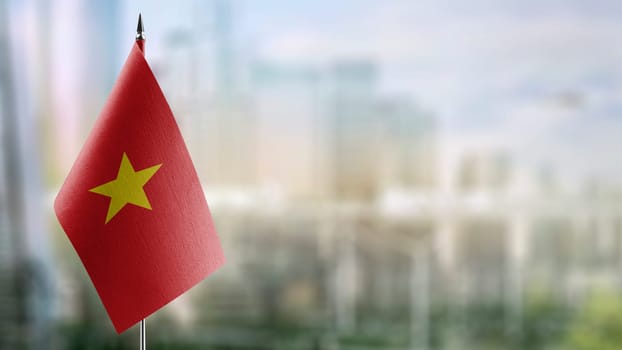 Small flags of the Vietnam on an abstract blurry background.