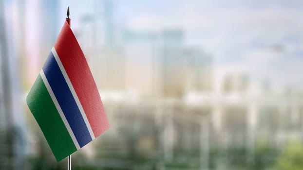 Small flags of the Gambia on an abstract blurry background.