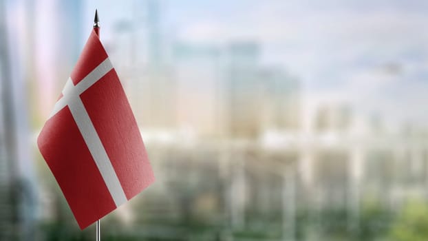 Small flags of the Denmark on an abstract blurry background.