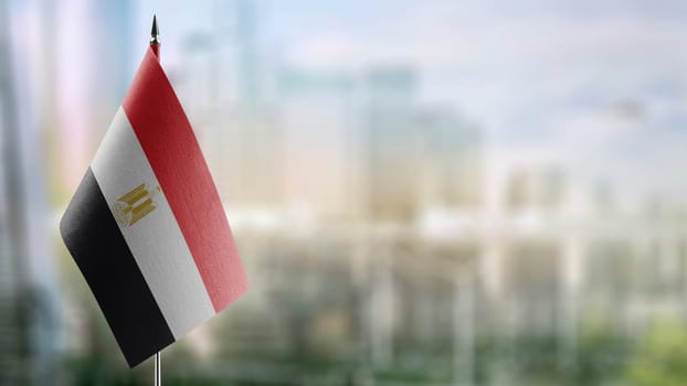 Small flags of the Egypt on an abstract blurry background.