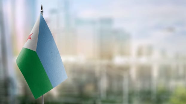 Small flags of the Djibouti on an abstract blurry background.