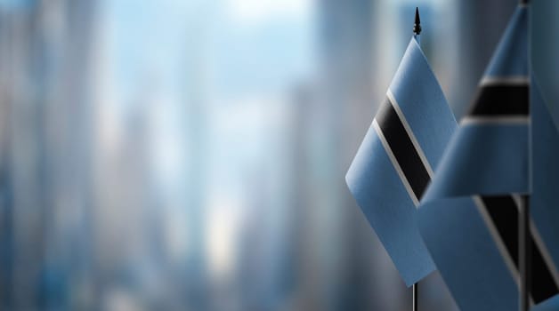 Small flags of the Botswana on an abstract blurry background.