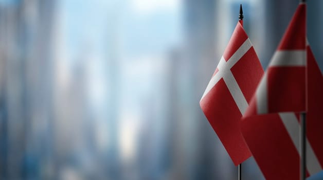 Small flags of the Denmark on an abstract blurry background.