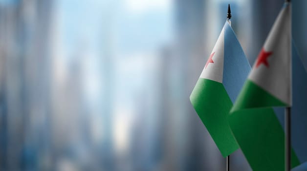 Small flags of the Djibouti on an abstract blurry background.