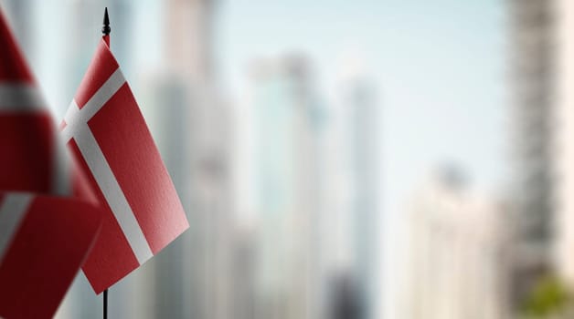 Small flags of the Denmark on an abstract blurry background.