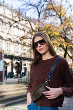 Close up shot of stylish young woman in sunglasses at the street. Beautiful female model.