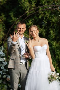 wedding ceremony of the newlyweds on the glade near the restaurant