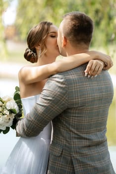 the first meeting of the bride and groom in wedding outfits in the park