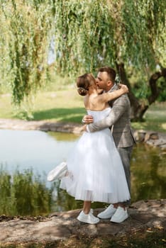 the first meeting of the bride and groom in wedding outfits in the park