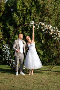 wedding ceremony of the newlyweds on the glade near the restaurant