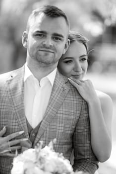 the first meeting of the bride and groom in wedding outfits in the park