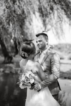 the first meeting of the bride and groom in wedding outfits in the park