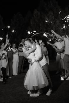 newlyweds at a wedding in the corridor of sparklers