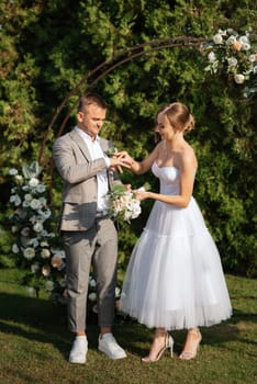 wedding ceremony of the newlyweds on the glade near the restaurant