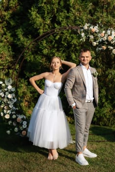 wedding ceremony of the newlyweds on the glade near the restaurant