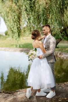 the first meeting of the bride and groom in wedding outfits in the park