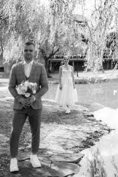 the first meeting of the bride and groom in wedding outfits in the park