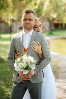 the first meeting of the bride and groom in wedding outfits in the park