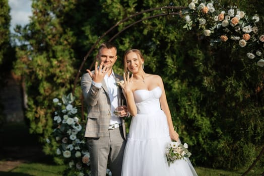 wedding ceremony of the newlyweds on the glade near the restaurant