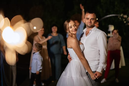 newlyweds at a wedding in the corridor of sparklers