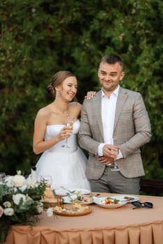 portrait of the newlyweds at the presidium at the wedding banquet