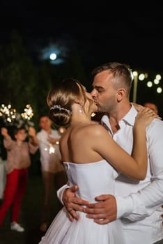 newlyweds at a wedding in the corridor of sparklers