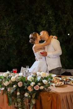 portrait of the newlyweds at the presidium at the wedding banquet