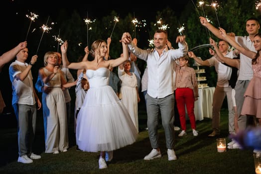 newlyweds at a wedding in the corridor of sparklers