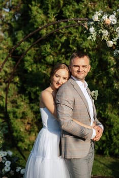 wedding ceremony of the newlyweds on the glade near the restaurant