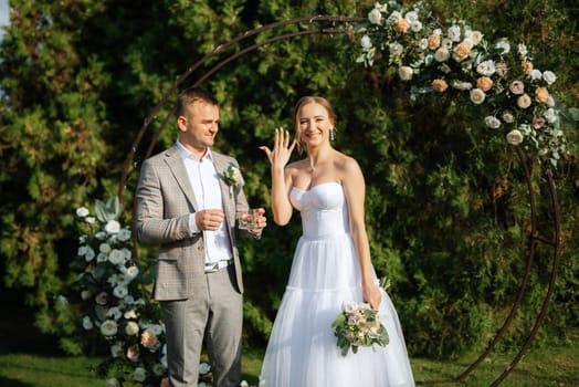 wedding ceremony of the newlyweds on the glade near the restaurant