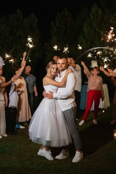 newlyweds at a wedding in the corridor of sparklers