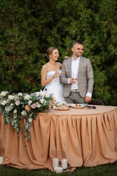 portrait of the newlyweds at the presidium at the wedding banquet