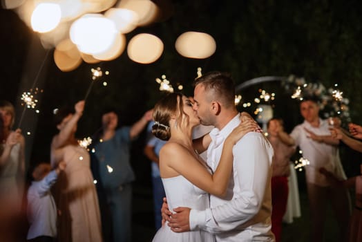 newlyweds at a wedding in the corridor of sparklers