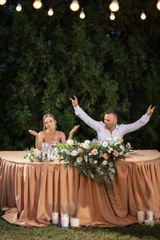 portrait of the newlyweds at the presidium at the wedding banquet