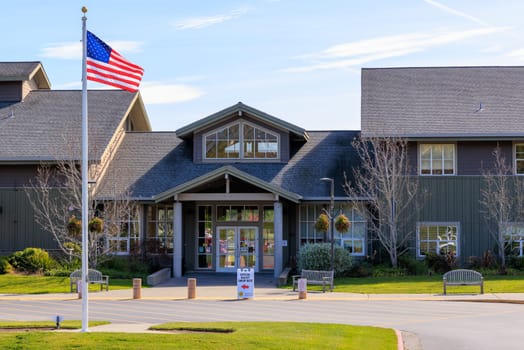 American flag flies over empty local polling station during local election. High quality photo