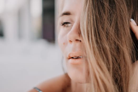 Happy woman portrait in cafe. Boho chic fashion style. Outdoor photo of young happy woman with long hair, sunny weather outdoors sitting in modern cafe