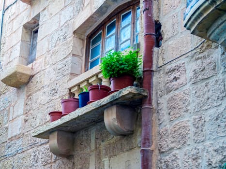 Fragment of the building's facade with traditional wooden ornate balconies painted in Valletta, Malta. High quality photo