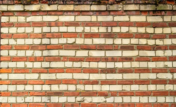 Abstract background brick red and white wall. An old building destroyed by atmospheric phenomena.