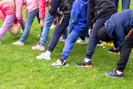 Children playing a sports game with a ball. Outdoor entertainment. Sports competition and leisure.